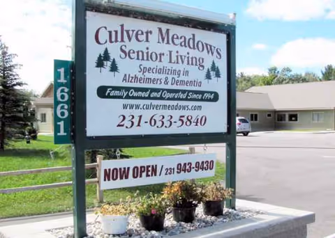 Culver Meadows Senior Living exterior sign with building and parking lot in background.