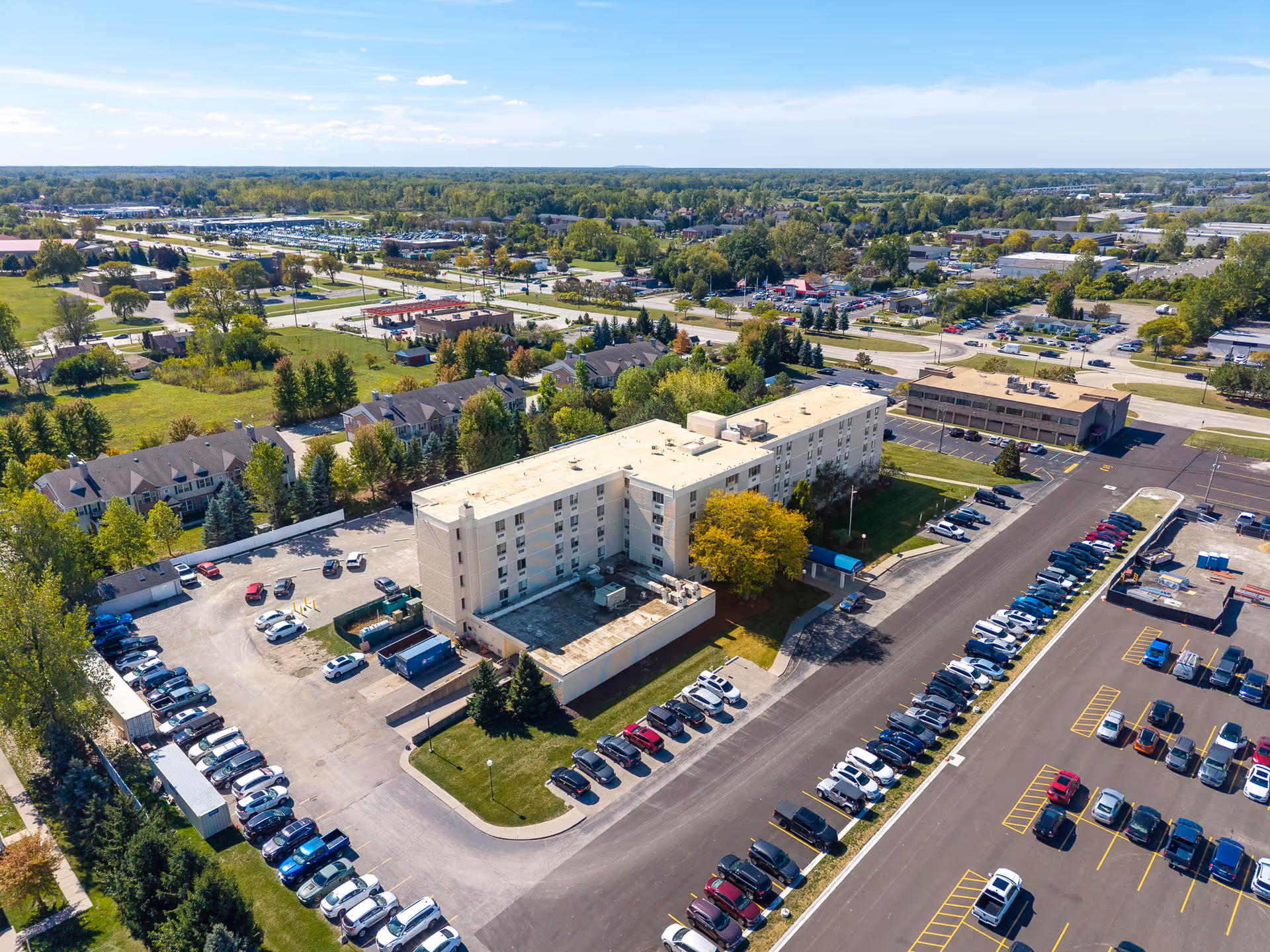 Aerial view of the Regency, a Villa Center senior living facility with parking lots and surrounding greenery.