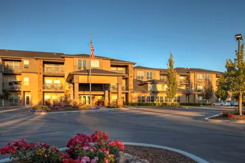 Exterior view of MorningStar Senior Living of Boise building with entrance, flag, and landscaping.