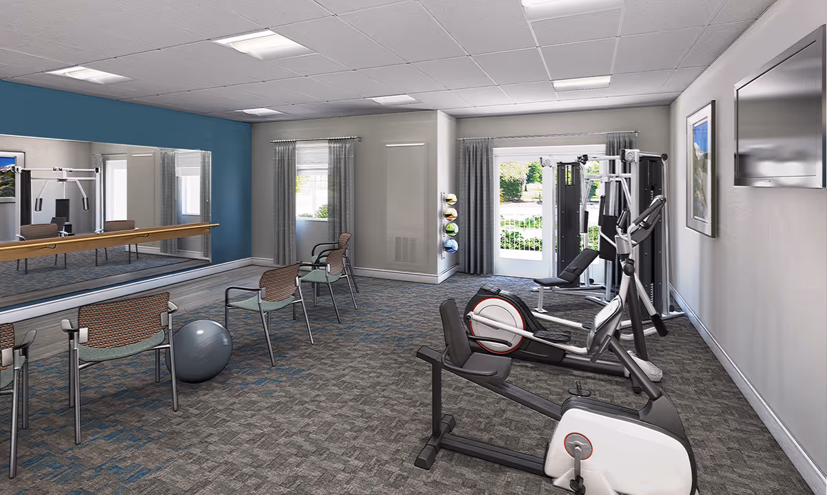 A bright exercise room with stationary bikes, strength machines, a mirrored wall, chairs, and an exercise ball.