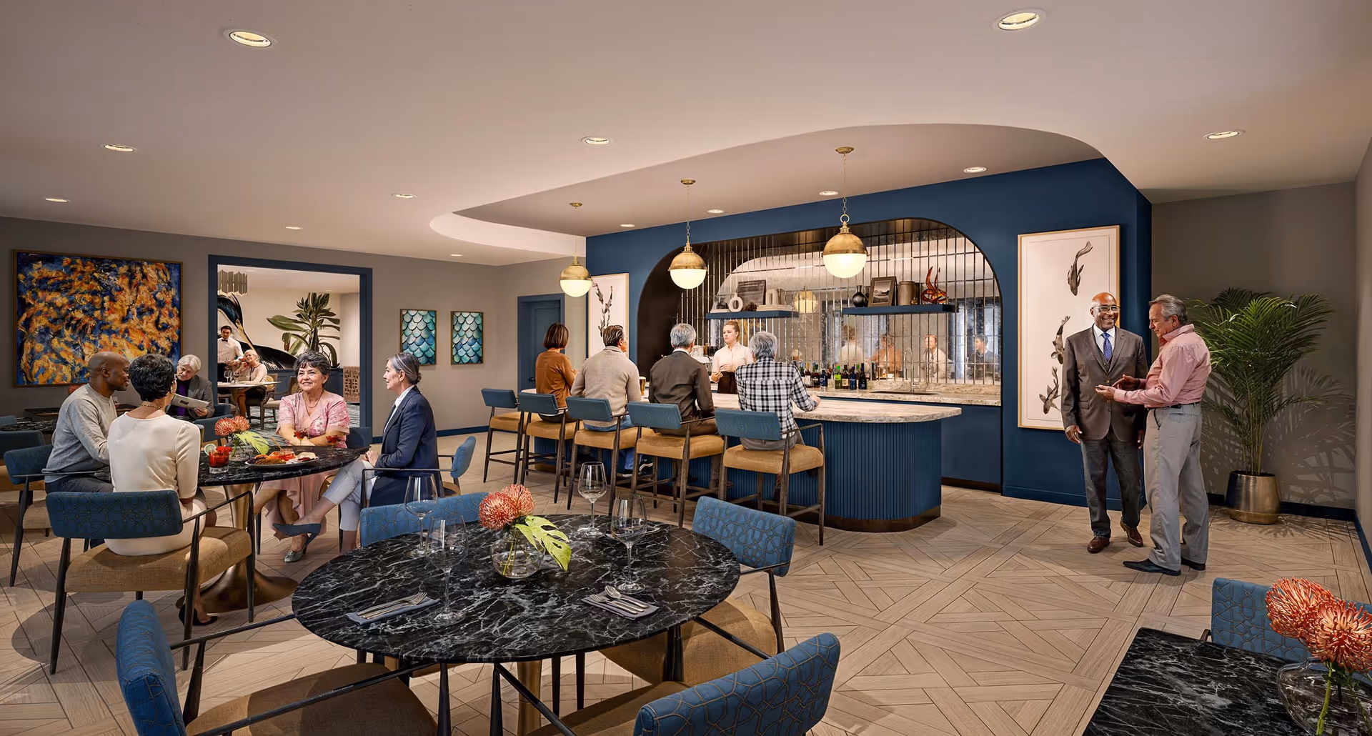 A stylish communal dining and lounge area with round marble tables, a curved bar, and people seated and chatting.