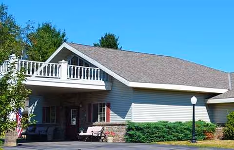 Front exterior view of Mountain Terrace Senior Living building with porch and landscaping.