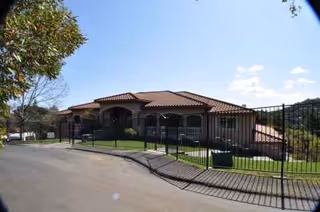 A single-story Bayview Villa senior living building with a gated entrance and landscaping.