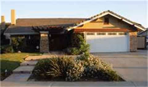 A single-story home with a two-car garage and manicured front yard.