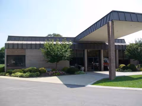Front exterior of NHC Healthcare Scott building with entrance and landscaping.