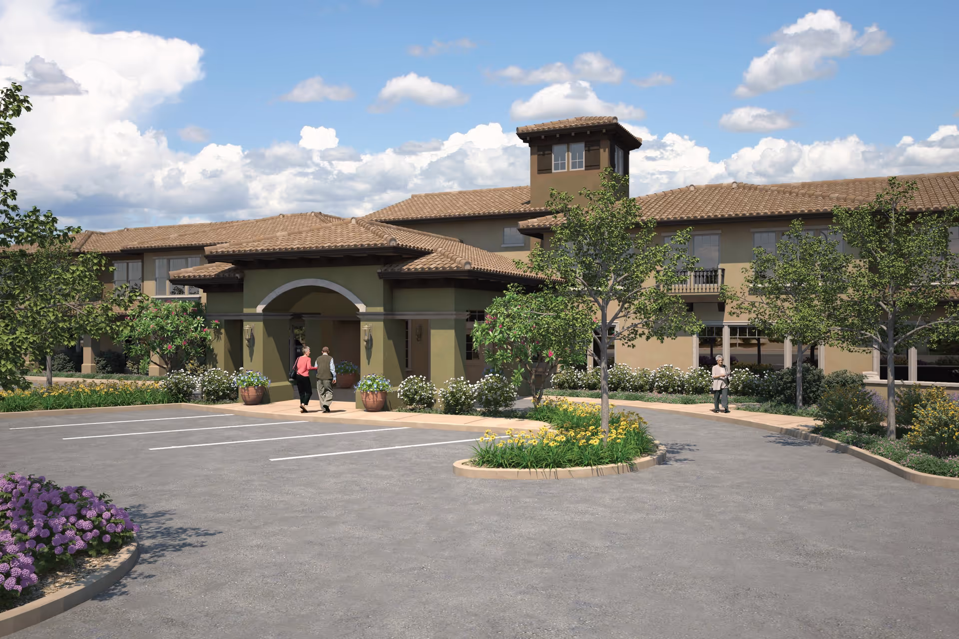 Exterior view of a senior living facility with a large entrance canopy, surrounded by landscaped greenery and trees. There are a few people walking near the entrance and a parking area in the foreground under a partly cloudy sky.