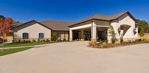 Front view of Providence Park Rehabilitation and Skilled Nursing facility with driveway and entrance.
