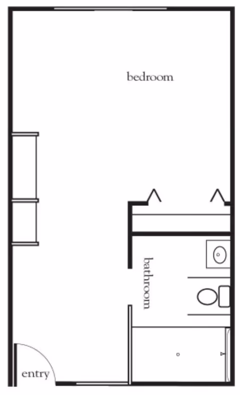 Floor plan layout showing a bedroom area, a bathroom with a toilet, sink, and shower, and an entry door.