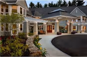 Exterior view of Riverwoods at Exeter entrance with curved driveway and landscaping.