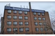 Brick multi-story care facility with signage reading Bronx Center for Rehabilitation and Nursing.