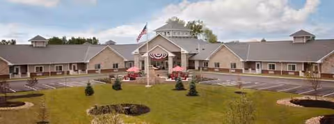 Exterior view of Bluebird Retirement Community with a central entrance and circular drive.
