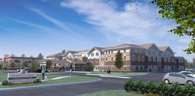 Exterior front view of a multi-story senior living facility with a driveway, landscaped grounds, sign, and parked cars.