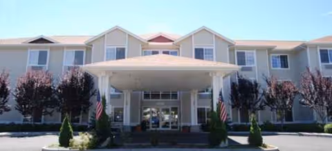 Exterior view of Brookdale Yakima front entrance with a covered drive and landscaping.
