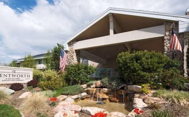 Front exterior of The Wentworth at East Millcreek with landscaping and a waterfall.