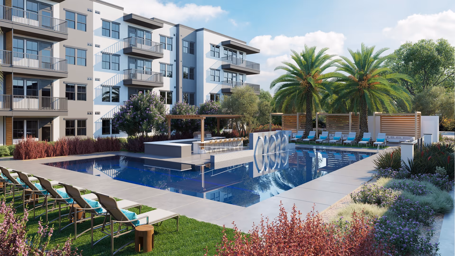 Outdoor pool area at Sage Mesa facility with lounge chairs, palm trees, and a modern building with balconies in the background under a partly cloudy sky.