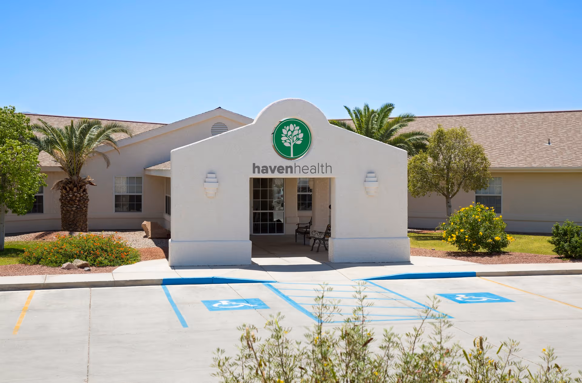 Front entrance of the Haven Health Lake Havasu building showing the covered entry with the havenhealth logo and accessible parking spaces in front.