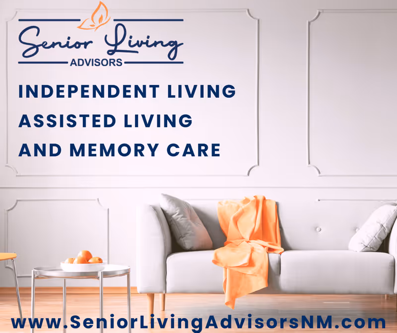 A modern living room with a light gray sofa adorned with two gray pillows and an orange throw blanket. A small round table with a bowl of oranges is placed next to the sofa. The wall behind features decorative molding and text promoting Senior Living Advisors services including Independent Living, Assisted Living, and Memory Care. The website www.SeniorLivingAdvisorsNM.com is displayed at the bottom.