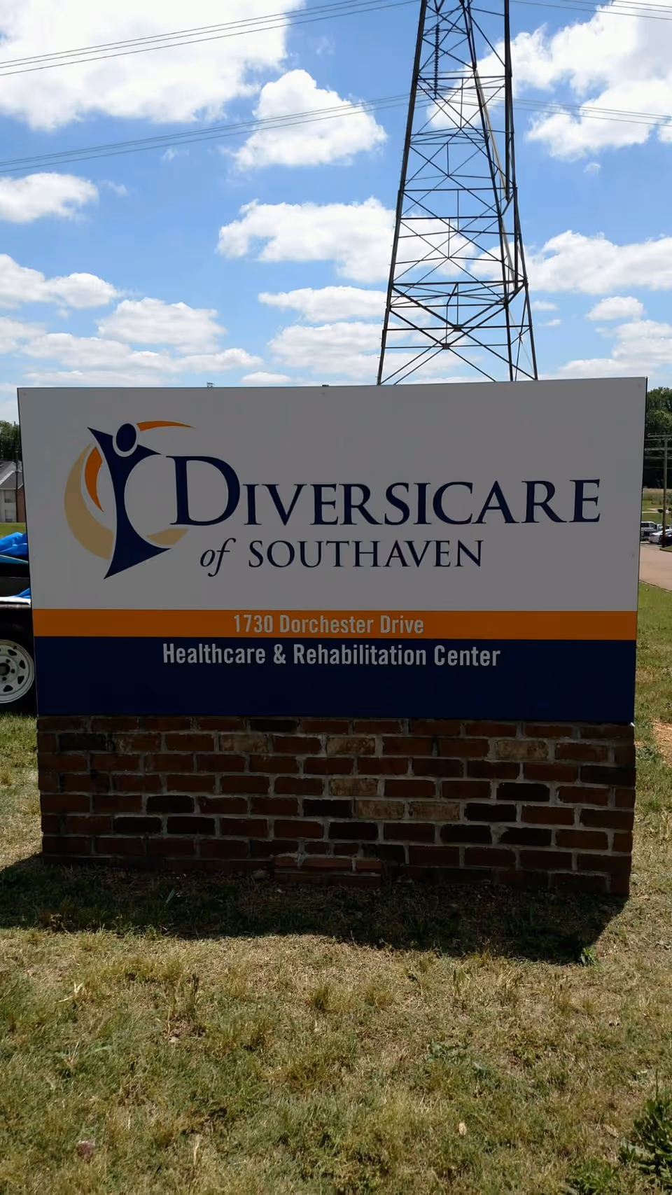 Outdoor sign for Diversicare of Southaven Healthcare & Rehabilitation Center located at 1730 Dorchester Drive, with a blue sky and power lines in the background.