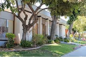 Exterior view of The Rehabilitation Center of North Hills with trees and a walkway.