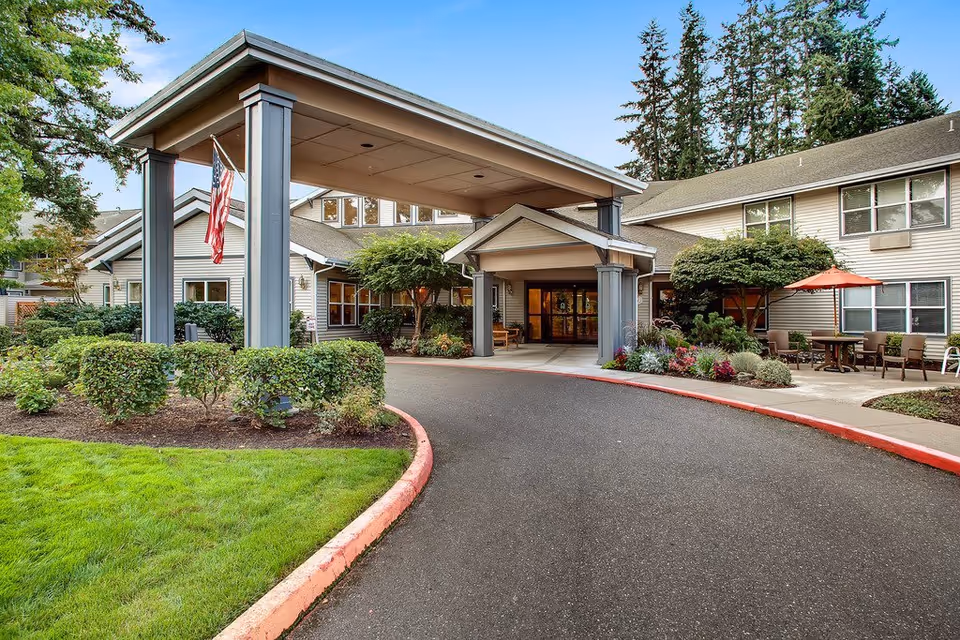 Exterior view of Canfield Place with a covered entrance, driveway, and outdoor seating area.