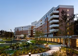 Whitney Center exterior: modern multi-story senior living building with brick and white facade.