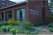 Brick building with Largo Landing Fellowship House sign and landscaped front garden.