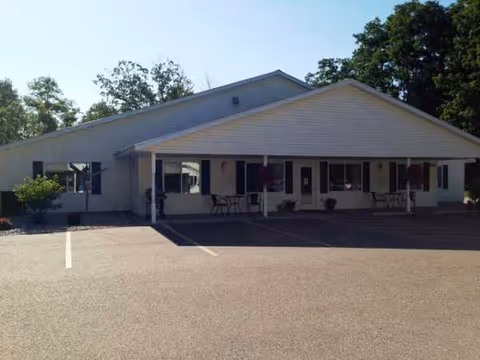 Front exterior of Care Partners Assisted Living-Stevens Point with a covered porch and parking.