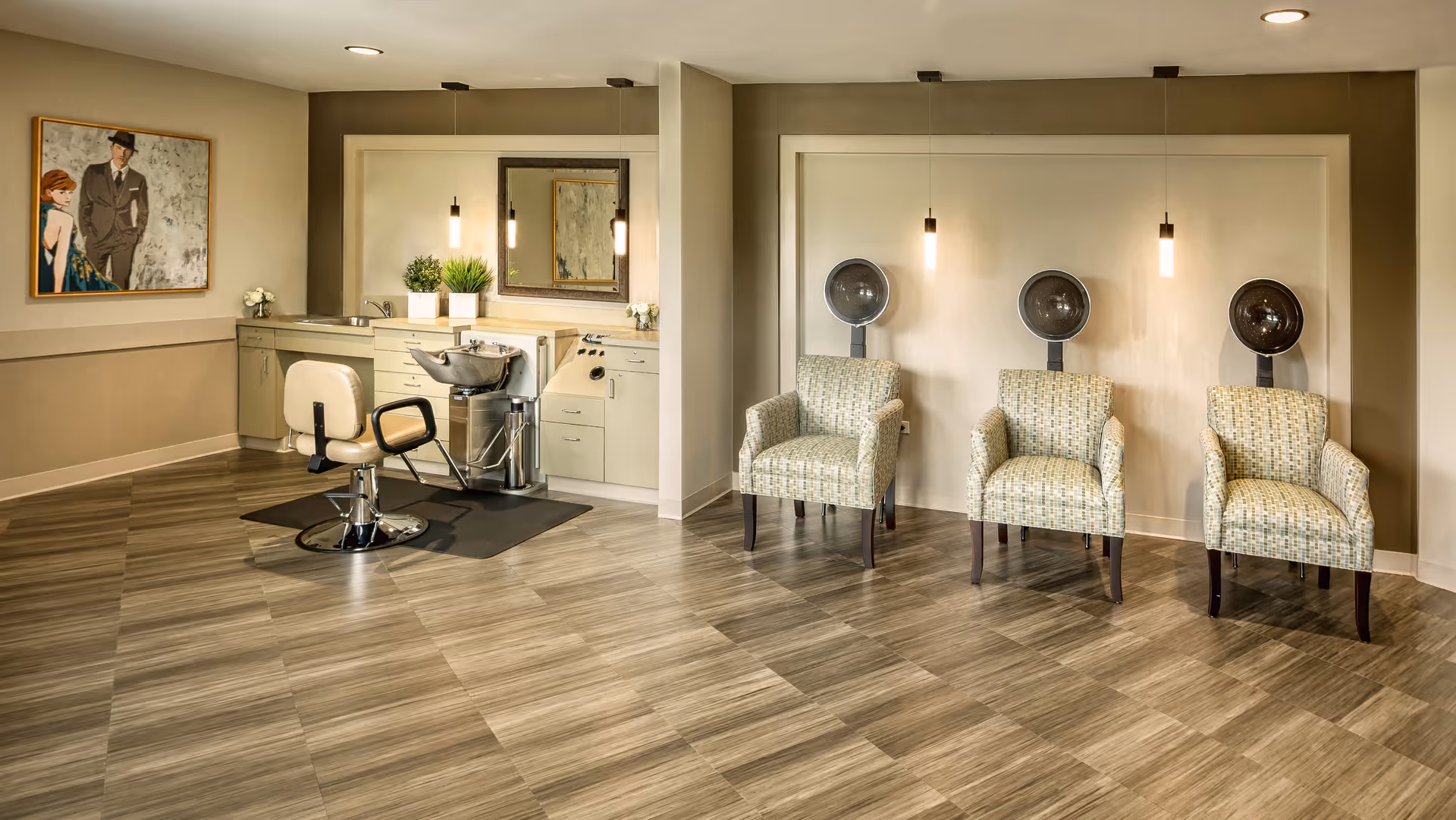 Spacious interior hair salon with a styling chair and wash basin on the left and three hooded dryers with armchairs on the right.