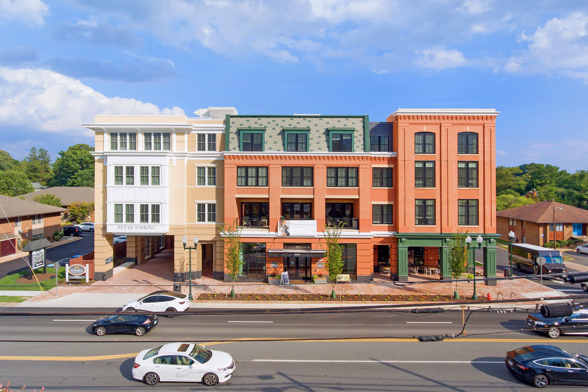Sunrise of Vienna senior living facility exterior along a busy street with a brick facade.