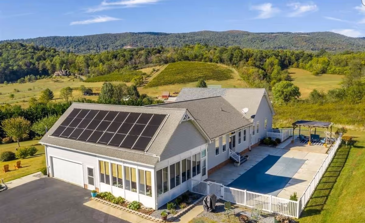 Exterior view of Acadia Care building featuring solar panels and a fenced outdoor patio.