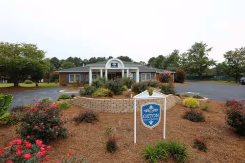 Front exterior of The Gardens of Social Circle with landscaped entrance and circular driveway.