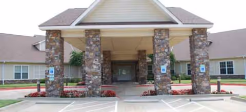Front view of Brookdale Chenal Heights entrance with stone pillars and porte-cochère.