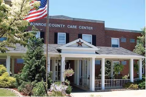 Stellar Care Center exterior: brick building with flag, covered entrance, and well-kept landscaping.