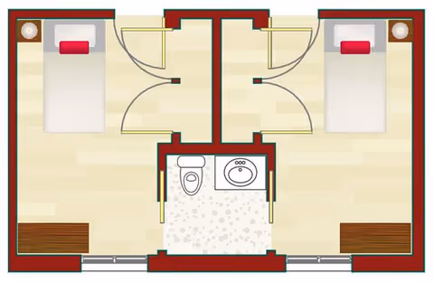 Floor plan of a memory care unit at Wyndemere Memory Care showing two separate bedrooms, each with a bed, nightstand, and dresser. The bedrooms share a central bathroom with a toilet and sink.