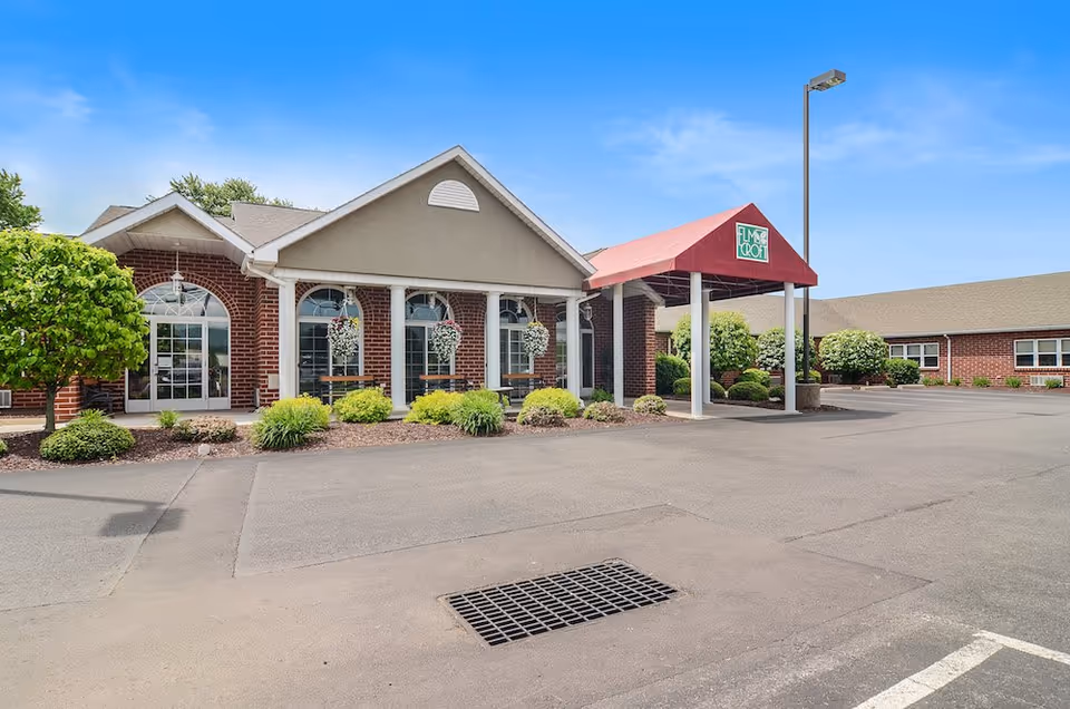 Exterior view of Celebration Villa Berwick with brick facade, entrance canopy, and landscaping.