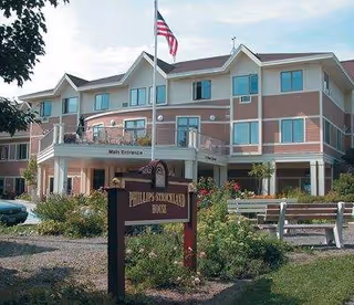 Exterior view of Phillips Strickland House senior living facility with main entrance.