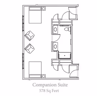 Architectural floor plan of a companion suite at Grand Brook Memory Care of Greenwood, showing two beds, two chairs, a bathroom with a toilet and shower, and closets, covering 578 square feet.