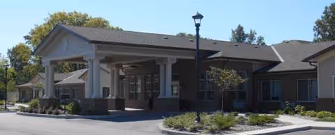 Front view of Heritage Point Assisted Living entrance with covered drop-off and landscaping.