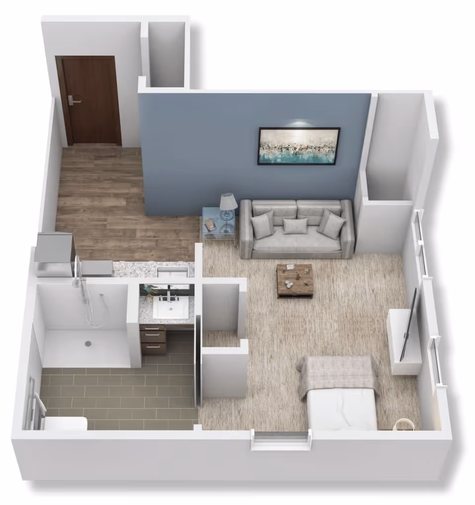 3D floor plan of a studio apartment featuring a living area with a sofa, coffee table, side table with lamp, and wall art. The sleeping area has a bed and a TV on a stand. The kitchen area includes a refrigerator and countertop with a sink. The bathroom has a shower, sink with vanity, and toilet. The entrance door opens into a small hallway with wood flooring.