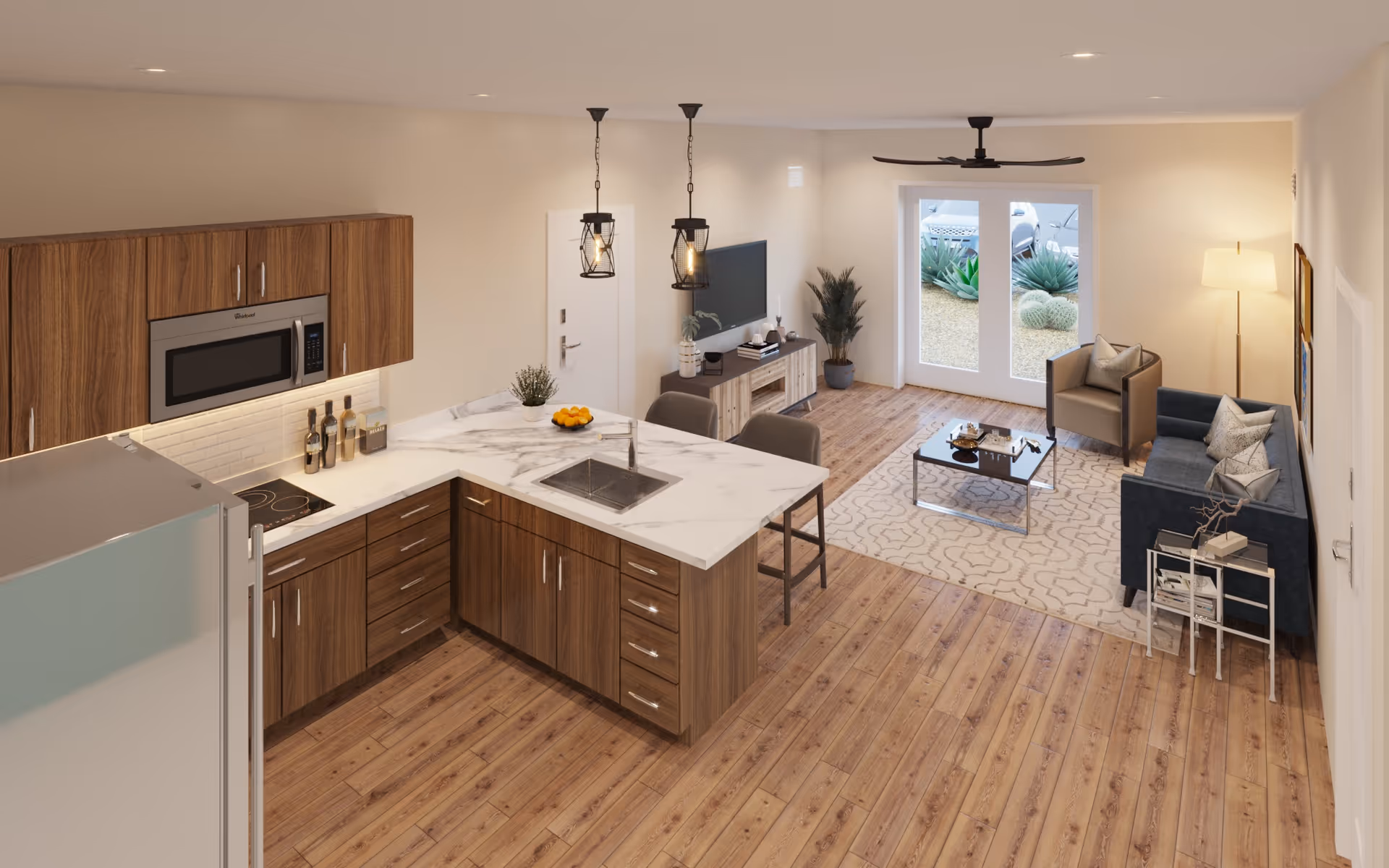 Open-plan interior showing a modern kitchen with a marble island in the foreground and a furnished living room with sofa, coffee table, TV, and glass doors in the background.