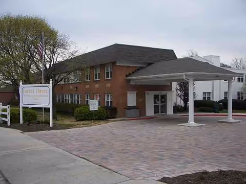 Exterior of Forest Haven Nursing and Rehabilitation Center with brick building and a covered entrance.