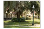 Front exterior view of Penney Retirement Community with lawn, trees, and a lamppost.