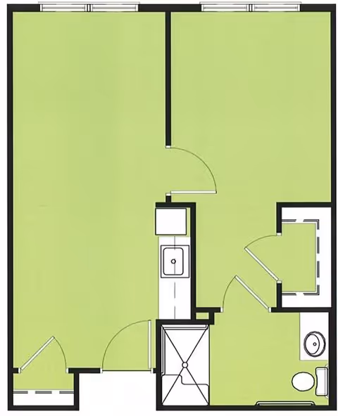 Floor plan of a residential unit showing a main living area, a kitchen with a sink, a bathroom with a toilet and shower, and an additional small room or closet space.