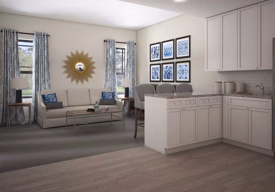 Open-plan living room and kitchen with a sofa, coffee table, bar counter with stools, and framed wall art.