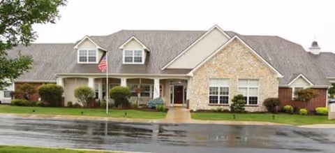 Front view of a Brookdale Greenville senior living facility with a manicured lawn.