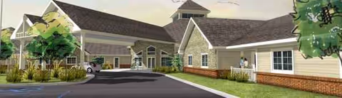 Front view of Bluebird Retirement Community exterior with entrance walkway and landscaping.