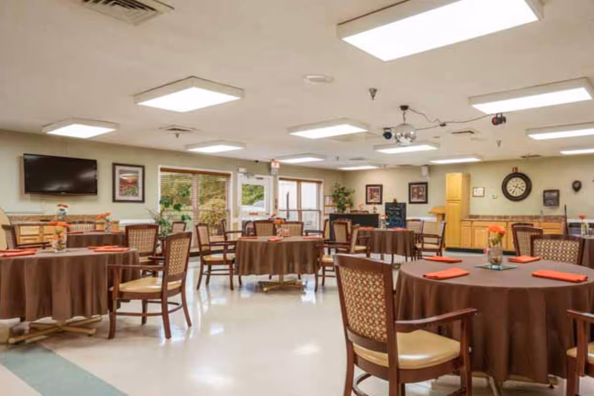 Dining room at Wilson Healthcare and Rehabilitation Center with round tables.