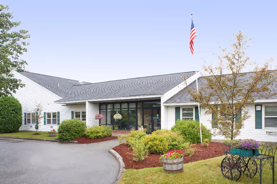 Exterior view of the Country Village Center senior living facility with landscaped gardens.