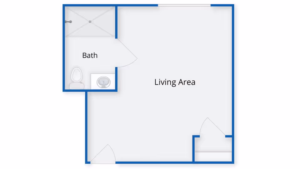 Floor plan of a small living space showing a living area and a bathroom with a toilet, sink, and shower.