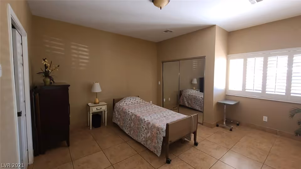 Simple single bedroom with a bed, nightstand, dresser, mirrored closet, and a window with shutters.